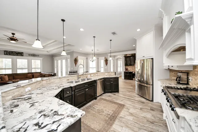 a kitchen with stainless steel appliances granite countertop a stove and a refrigerator