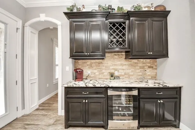 a kitchen with stainless steel appliances granite countertop a sink and cabinets