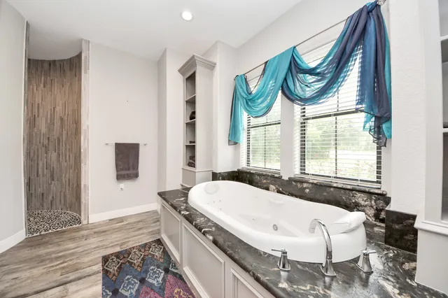 a bathroom with a granite countertop sink and a large mirror