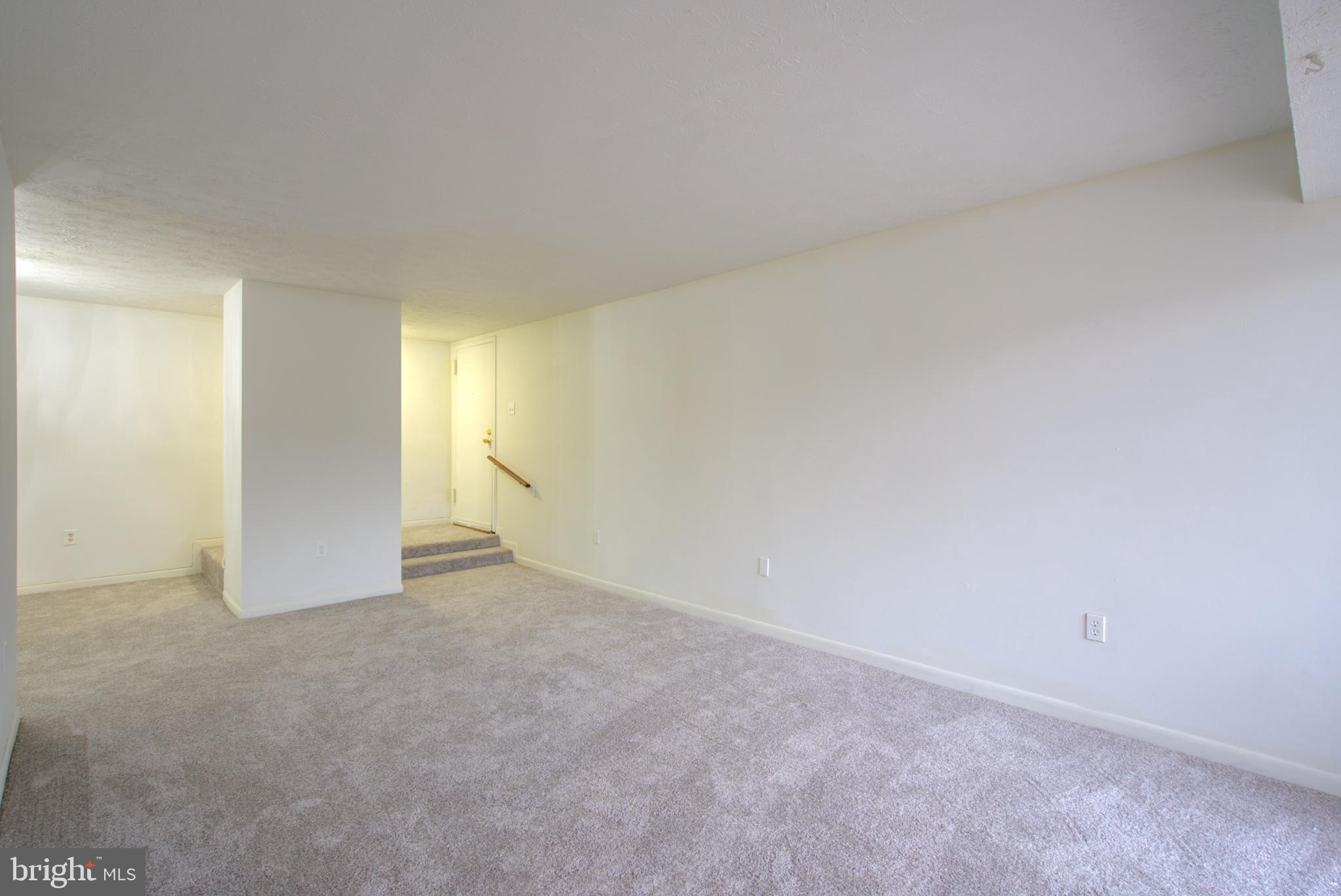 8011 Mandan Road, Unit 201 Greenbelt, MD 20770 - Photo 11 of 28 a view of an empty room and a window