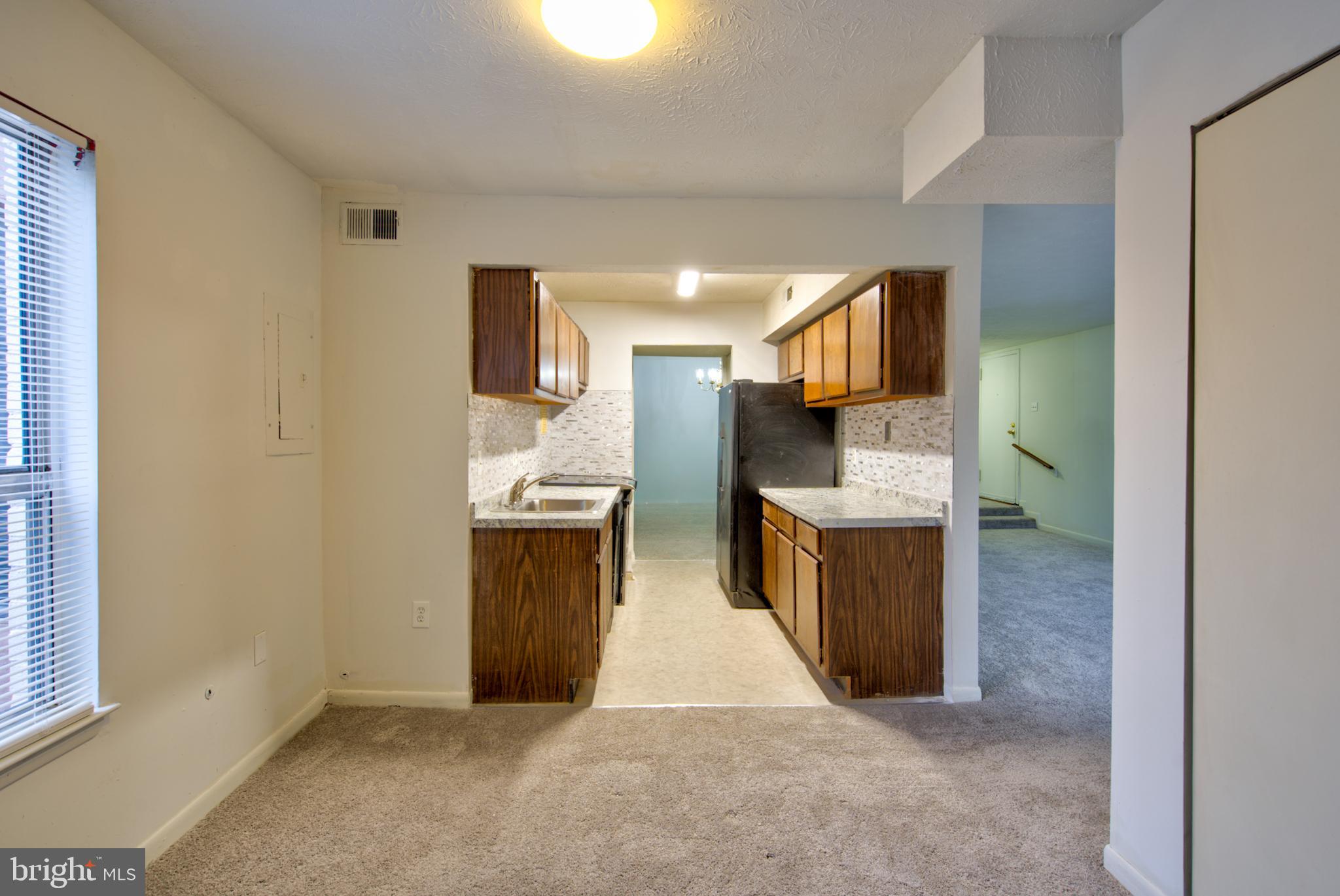 8011 Mandan Road, Unit 201 Greenbelt, MD 20770 - Photo 14 of 28 a kitchen with a refrigerator and a stove top oven