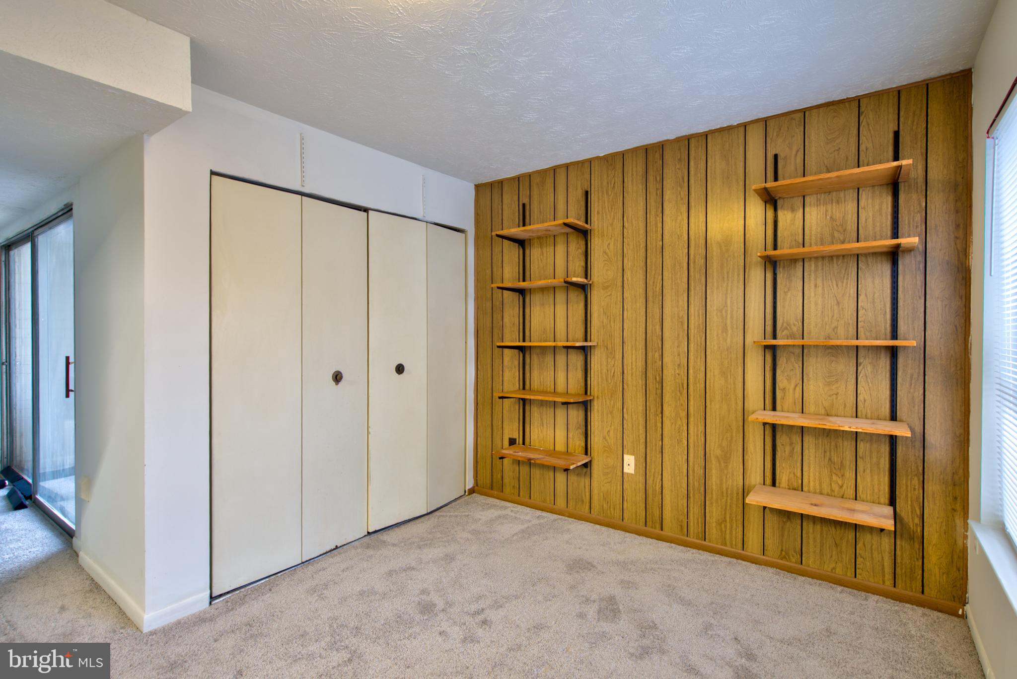 8011 Mandan Road, Unit 201 Greenbelt, MD 20770 - Photo 16 of 28 a view of an empty room with entrance and door