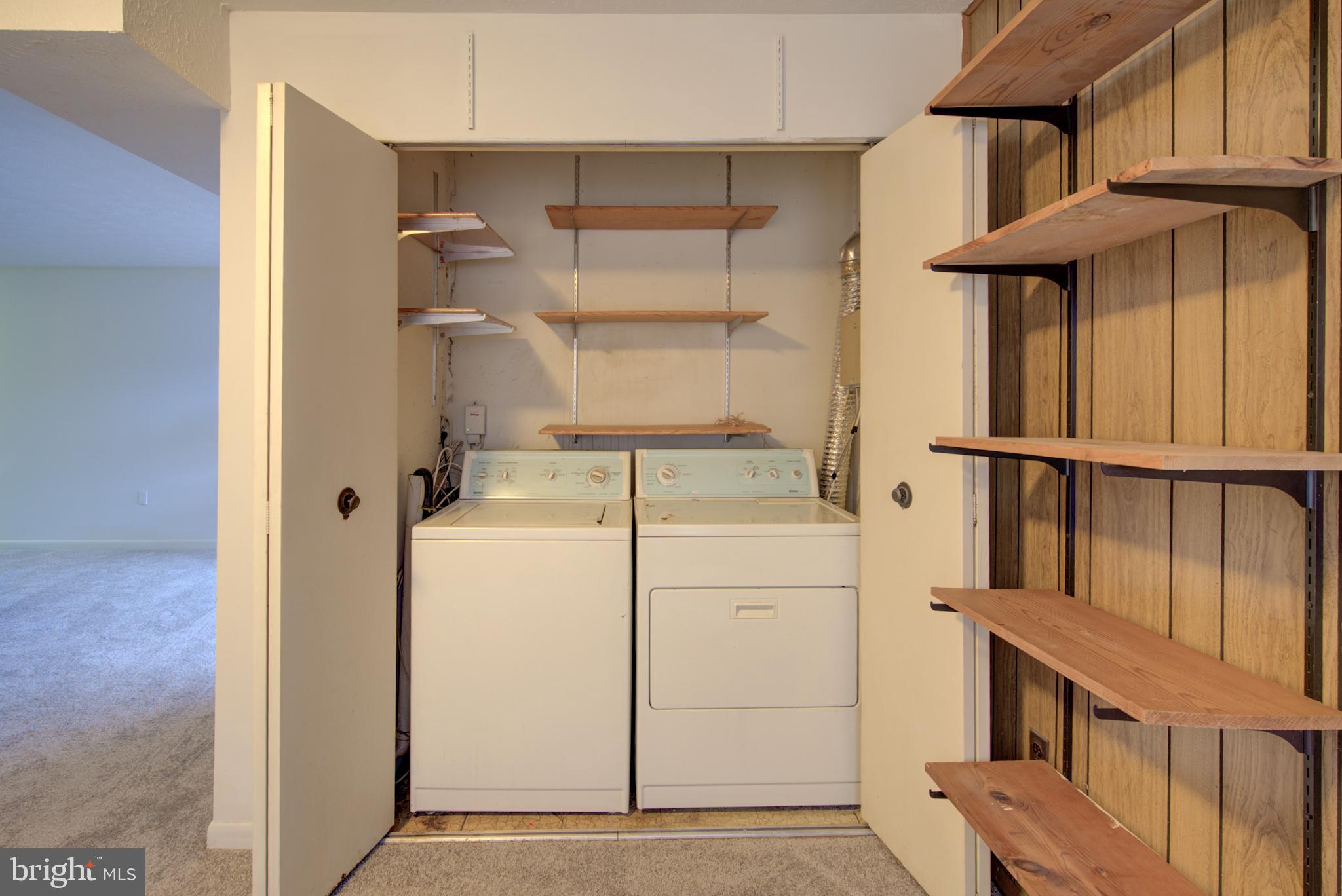 8011 Mandan Road, Unit 201 Greenbelt, MD 20770 - Photo 17 of 28 a view of storage and utility room with washer and dryer