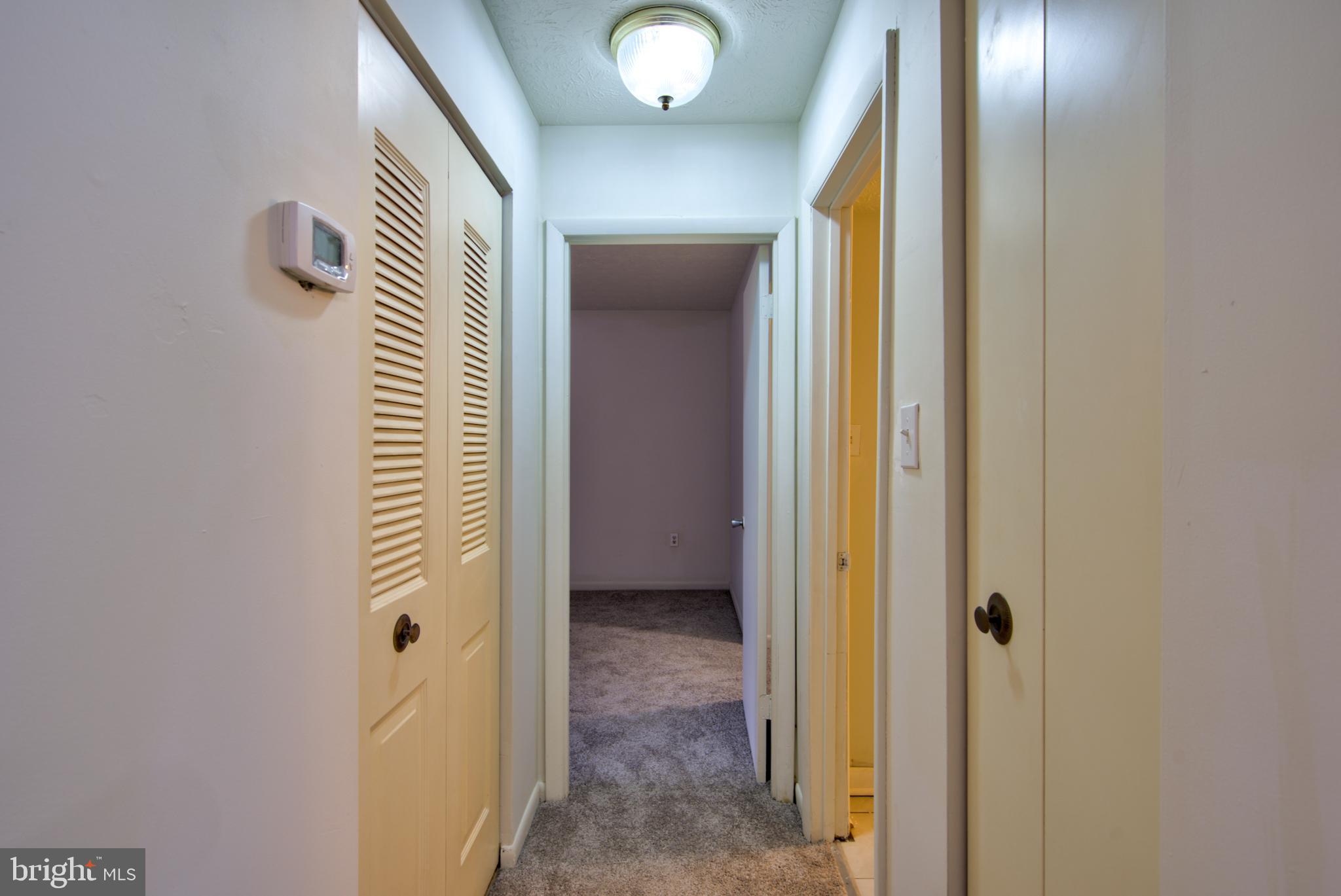 8011 Mandan Road, Unit 201 Greenbelt, MD 20770 - Photo 18 of 28 a view of a hallway with wooden floor and closet