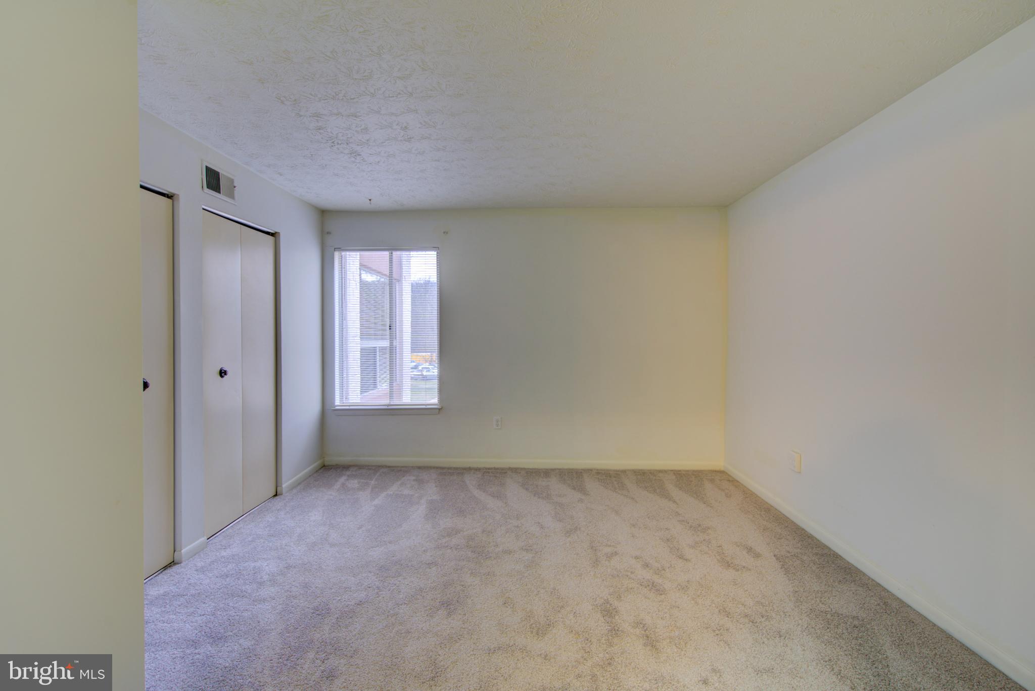 8011 Mandan Road, Unit 201 Greenbelt, MD 20770 - Photo 22 of 28 a view of an empty room and window
