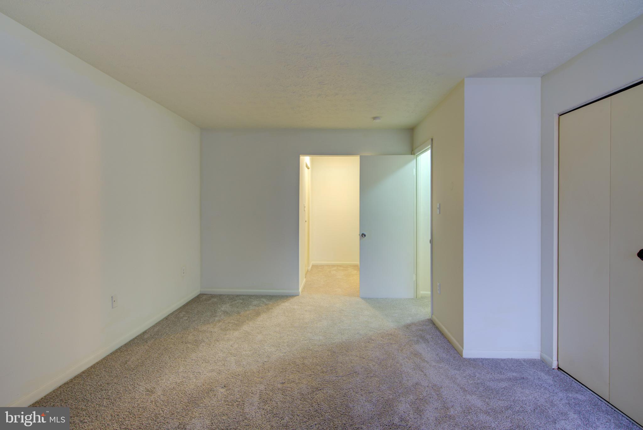 8011 Mandan Road, Unit 201 Greenbelt, MD 20770 - Photo 24 of 28 a view of an empty room with a window