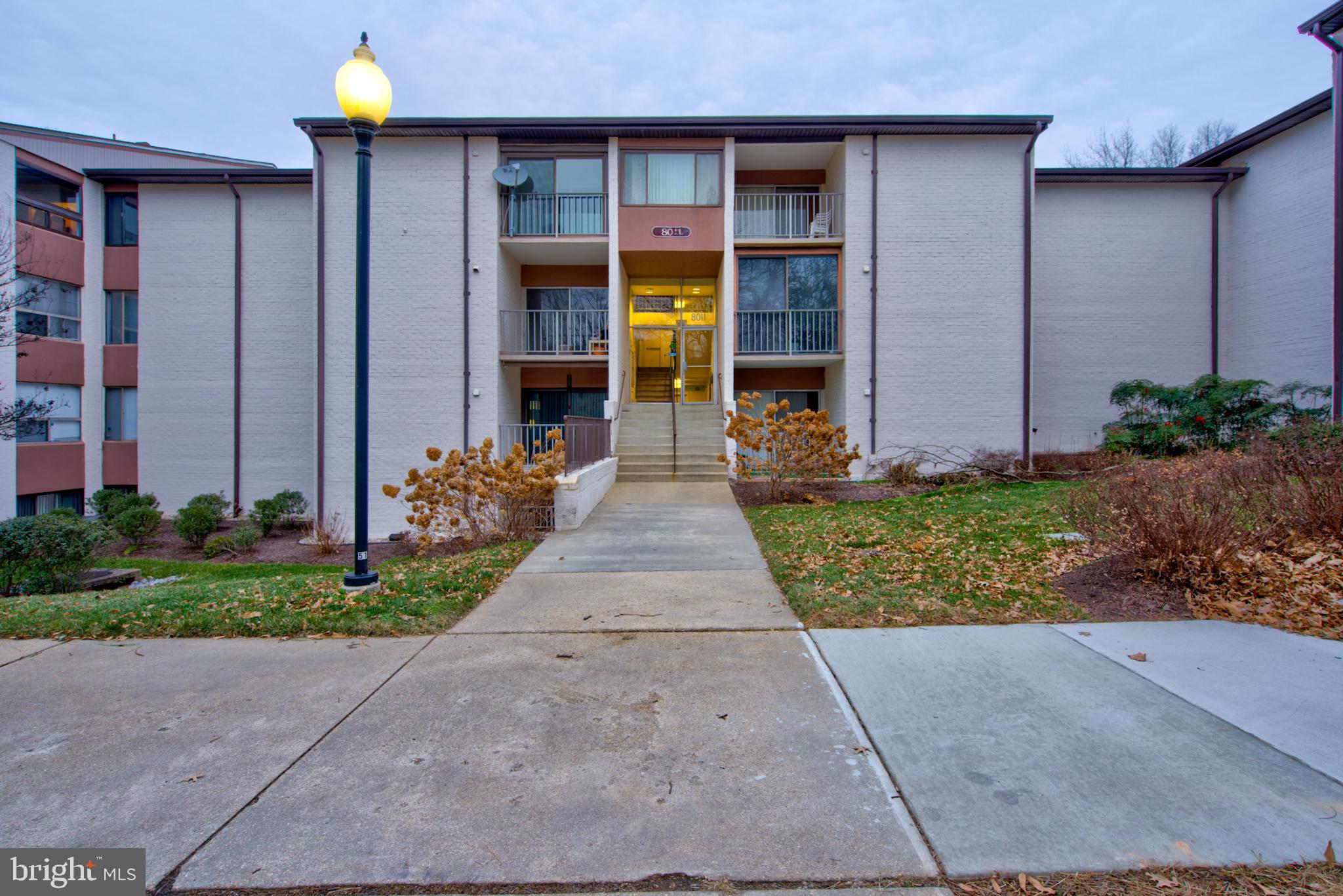 8011 Mandan Road, Unit 201 Greenbelt, MD 20770 - Photo 3 of 28 a front view of a house with garden