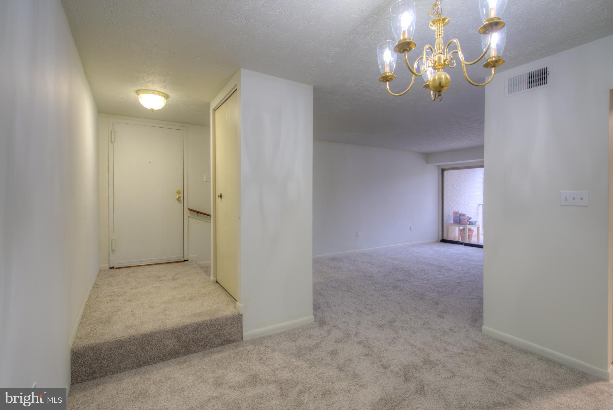 8011 Mandan Road, Unit 201 Greenbelt, MD 20770 - Photo 5 of 28 a view of livingroom with hardwood floor and kitchen view