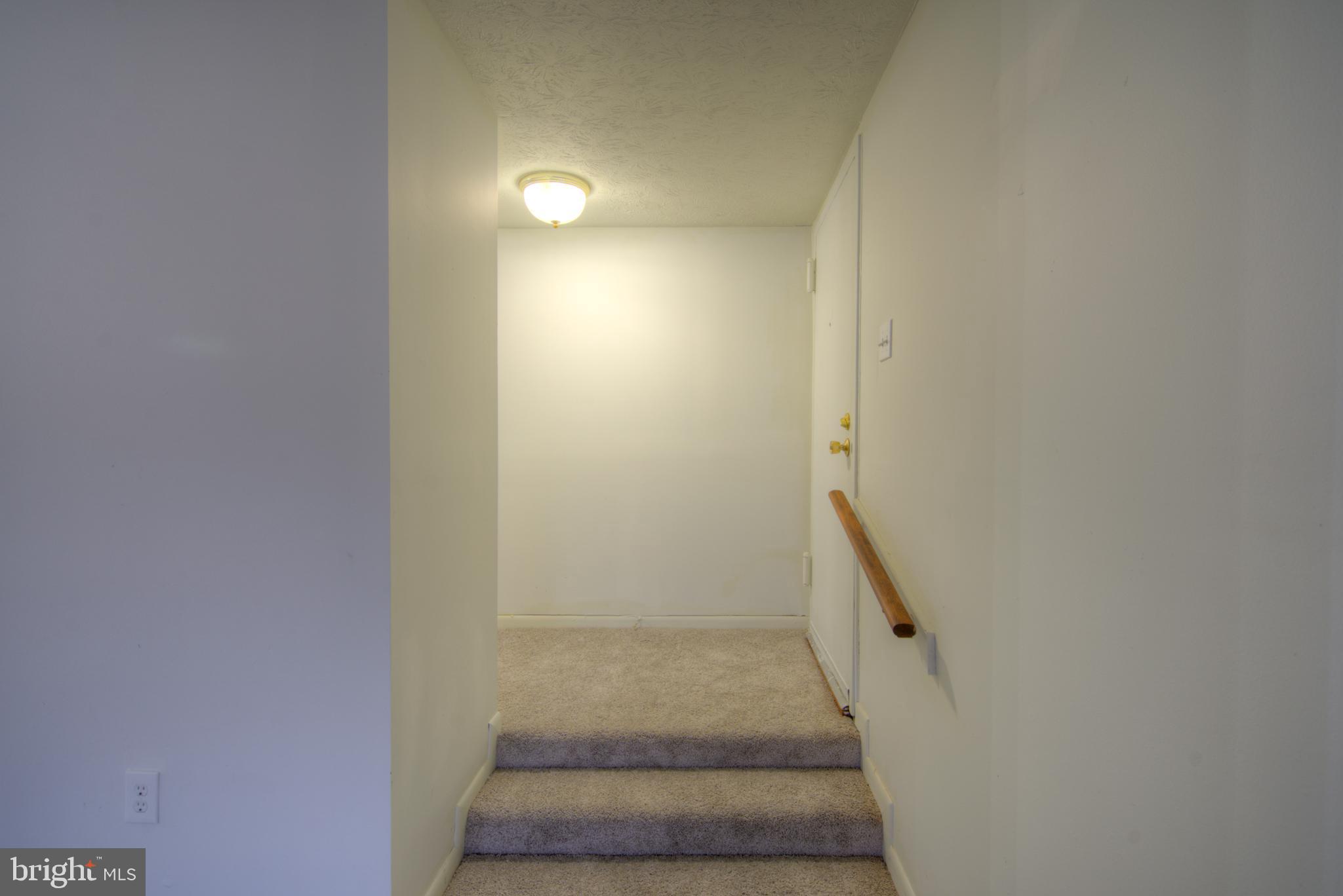 8011 Mandan Road, Unit 201 Greenbelt, MD 20770 - Photo 6 of 28 a view of staircase with white walls