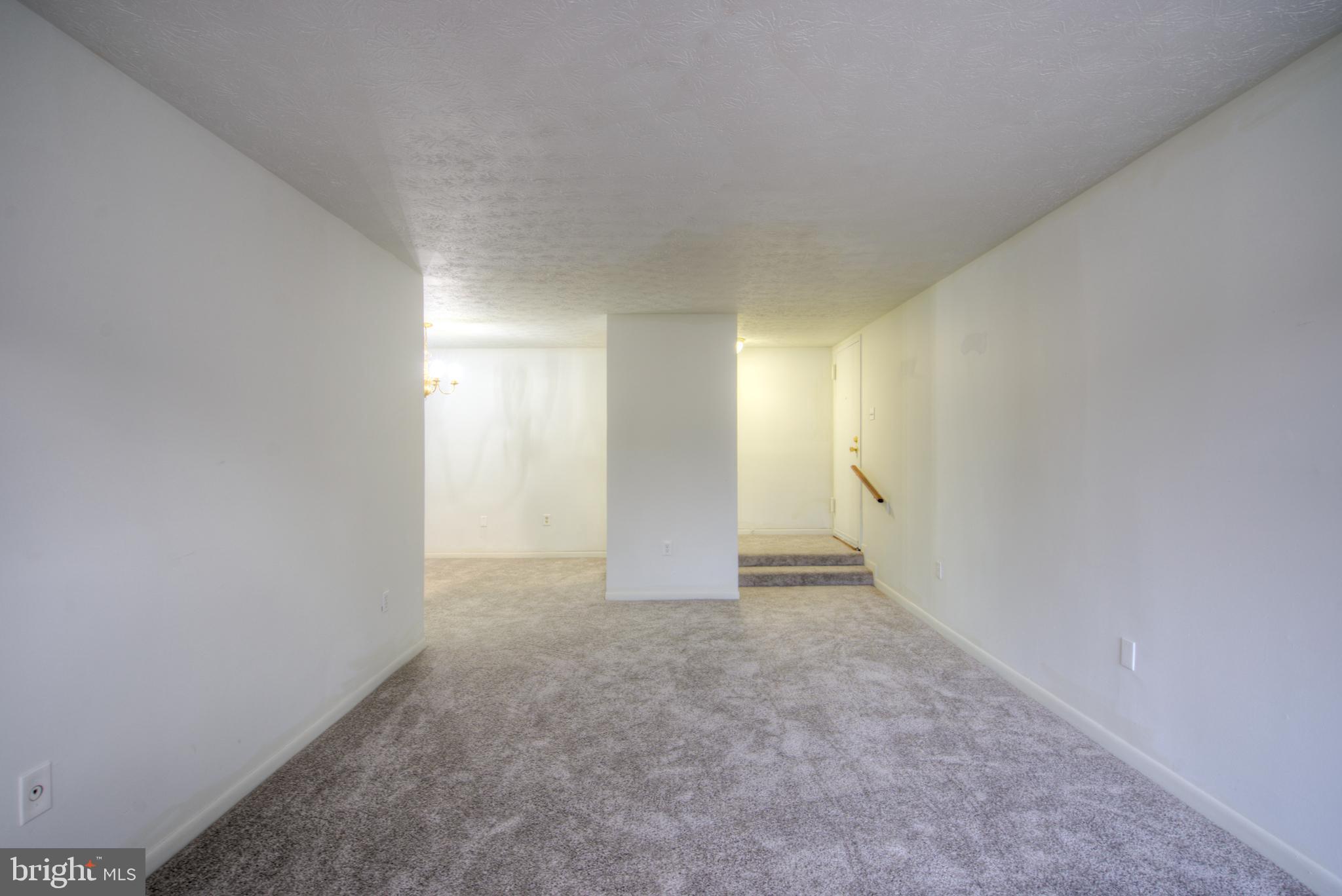 8011 Mandan Road, Unit 201 Greenbelt, MD 20770 - Photo 7 of 28 a view of an empty room and window