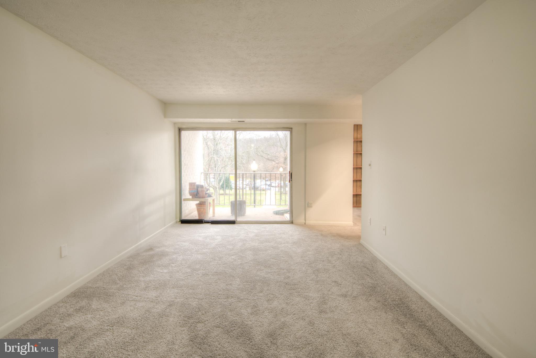 8011 Mandan Road, Unit 201 Greenbelt, MD 20770 - Photo 9 of 28 an empty room with windows