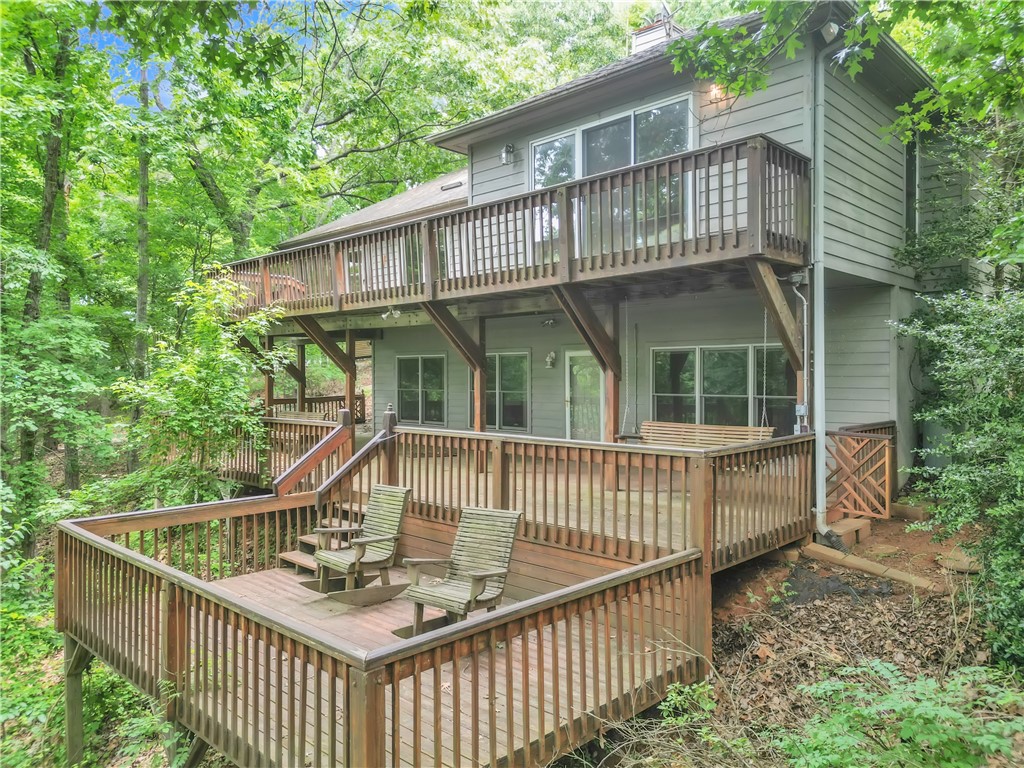 149 Inlet Pointe Drive Anderson, SC 29625 - Photo 33 of 43 Multi-level outdoor decks extend into a verdant, wooded landscape, creating an immersive natural retreat.