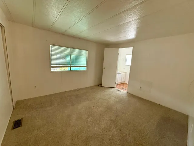 a bathroom with a granite countertop sink a toilet and a mirror