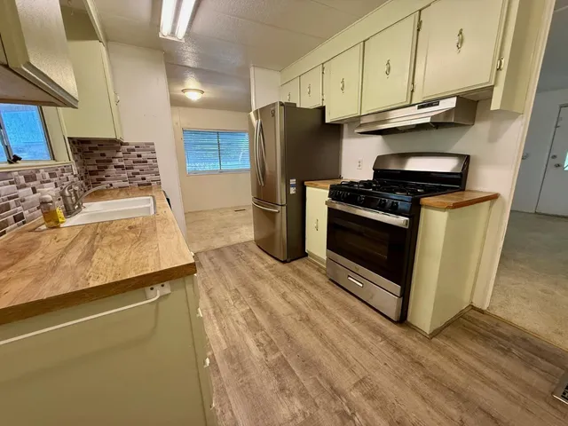 a kitchen with stainless steel appliances a stove and a refrigerator