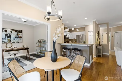 a view of a dining room with furniture a chandelier and wooden floor