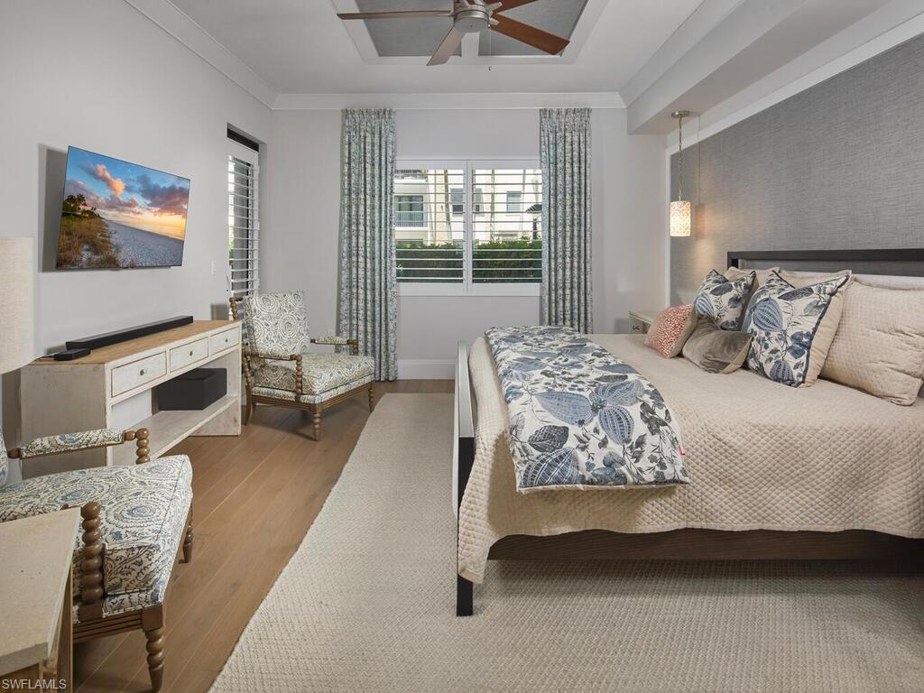 1135 3rd Avenue South Naples, FL 34102 - Photo 12 of 35 a bedroom with a bed and glass wall