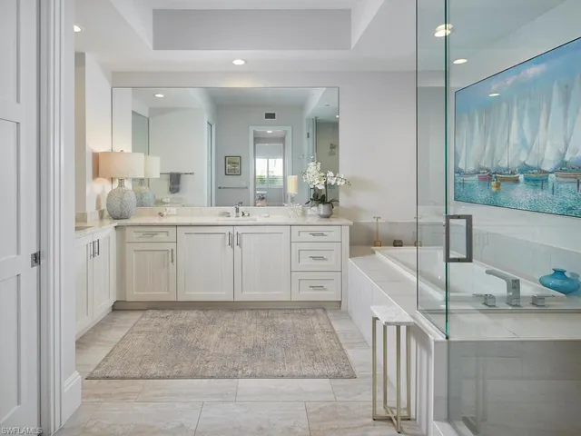 a large white kitchen with a sink and dishwasher