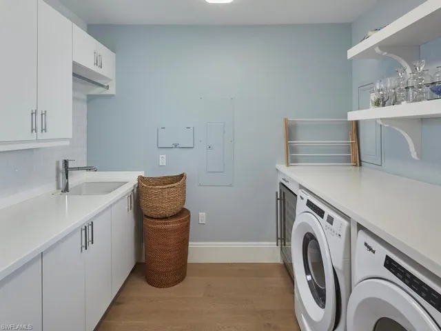a utility room with sink dryer and washer