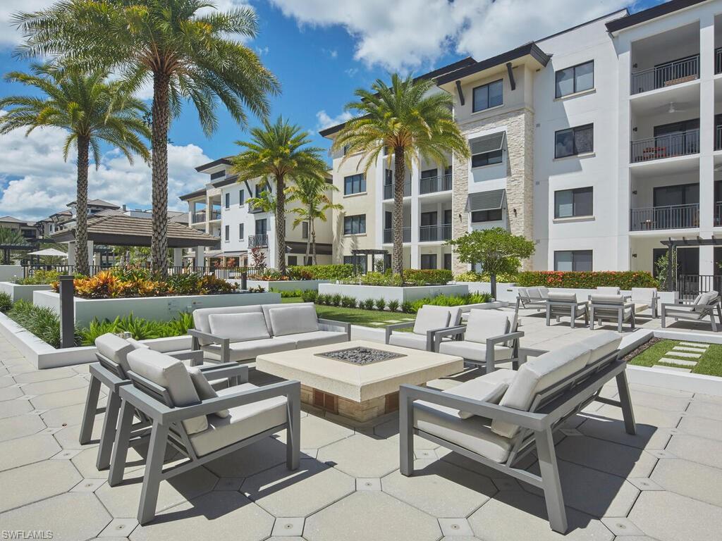 1135 3rd Avenue South Naples, FL 34102 - Photo 22 of 35 a view of a patio with swimming pool and chairs