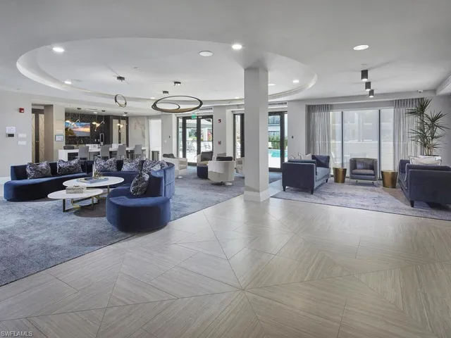 a living room with furniture and large windows