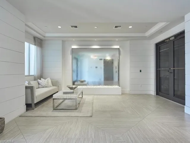 a living room with furniture and a chandelier