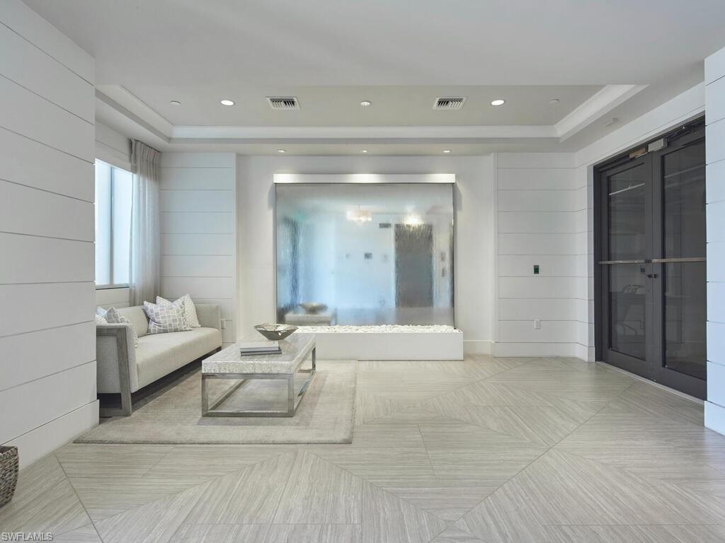 1135 3rd Avenue South Naples, FL 34102 - Photo 32 of 35 a living room with furniture and a chandelier