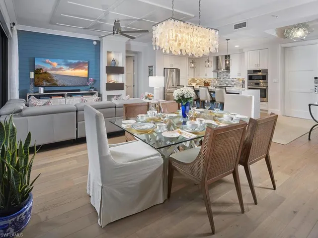 a view of a dining room with furniture a chandelier and wooden floor