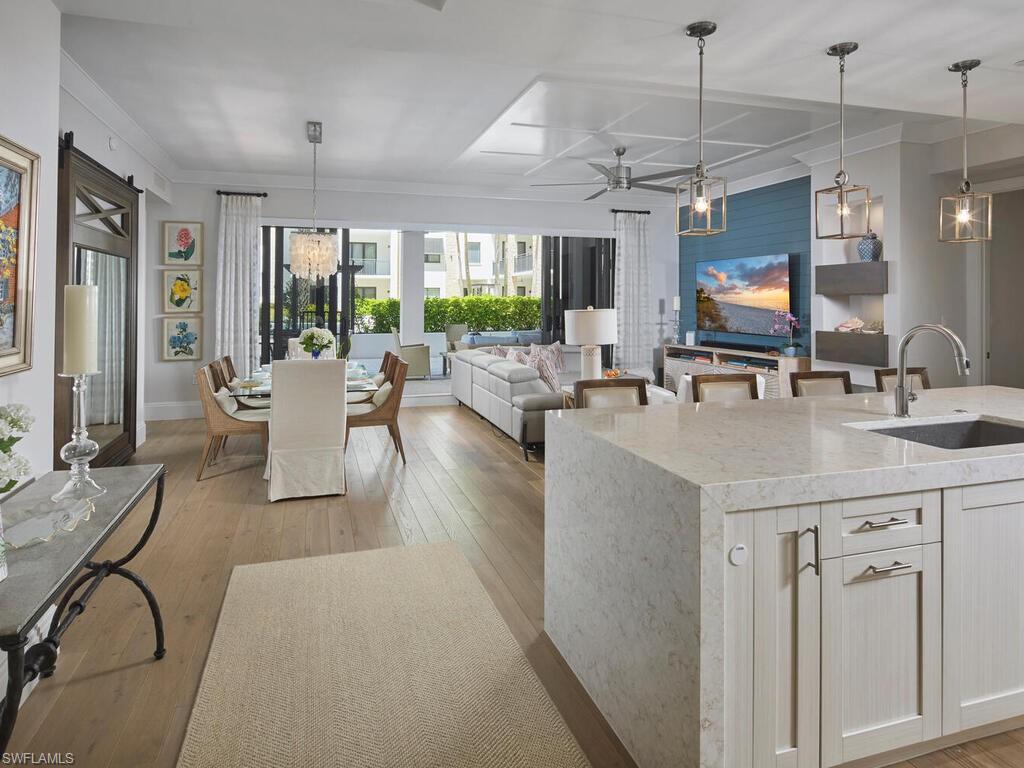 1135 3rd Avenue South Naples, FL 34102 - Photo 6 of 35 a living room with granite countertop furniture a flat screen tv and a large window