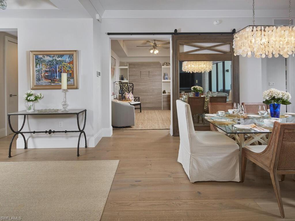 1135 3rd Avenue South Naples, FL 34102 - Photo 7 of 35 a living room with furniture and a chandelier