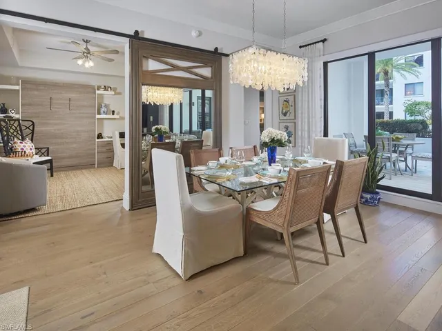 a view of a dining room with furniture wooden floor and chandelier