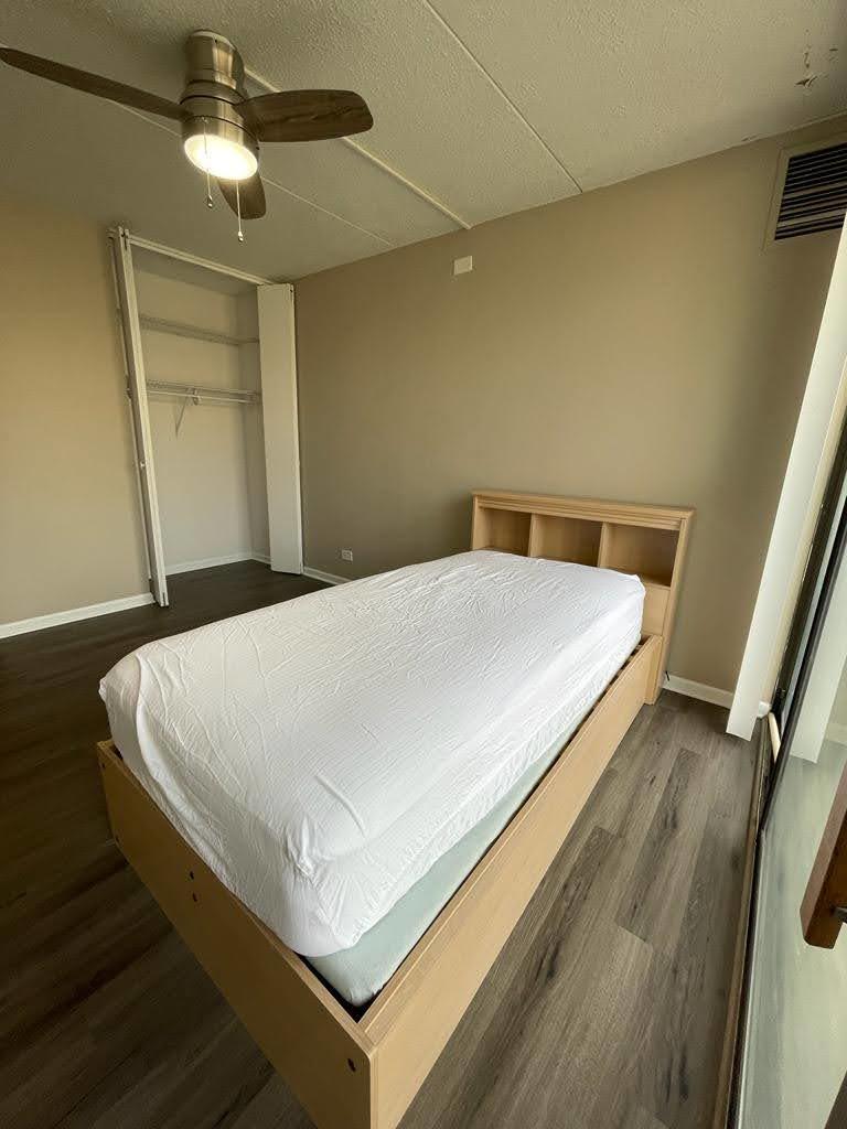 2015 South Finley Road, Unit 212 Lombard, IL 60148 - Photo 11 of 26 a bed sitting in a bedroom next to a bathroom