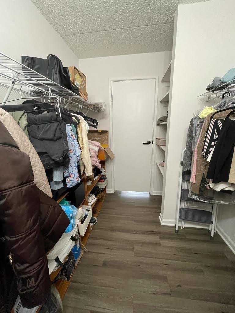 2015 South Finley Road, Unit 212 Lombard, IL 60148 - Photo 13 of 26 a view of walk in closet with clothes and shoes