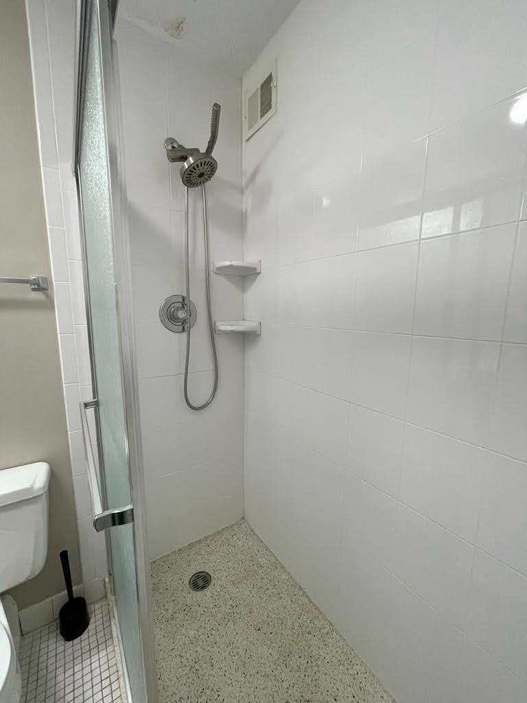 2015 South Finley Road, Unit 212 Lombard, IL 60148 - Photo 14 of 26 a bathroom with a shower and toilet