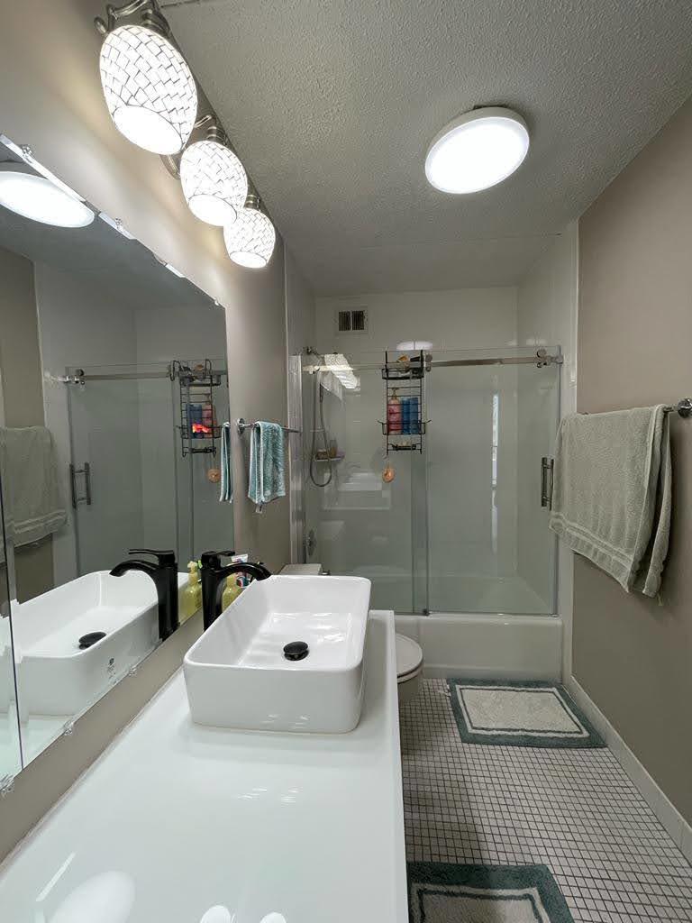 2015 South Finley Road, Unit 212 Lombard, IL 60148 - Photo 18 of 26 a bathroom with a sink a toilet and shower