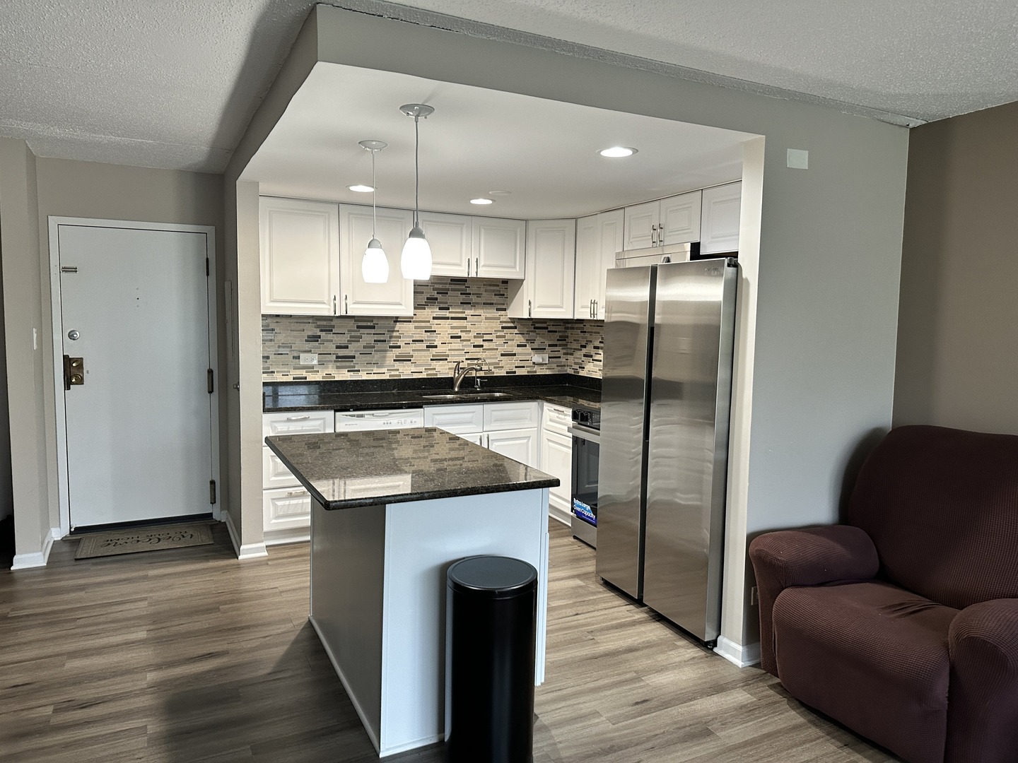 2015 South Finley Road, Unit 212 Lombard, IL 60148 - Photo 3 of 26 a kitchen with stainless steel appliances granite countertop a refrigerator a oven a stove and a refrigerator with wooden floor