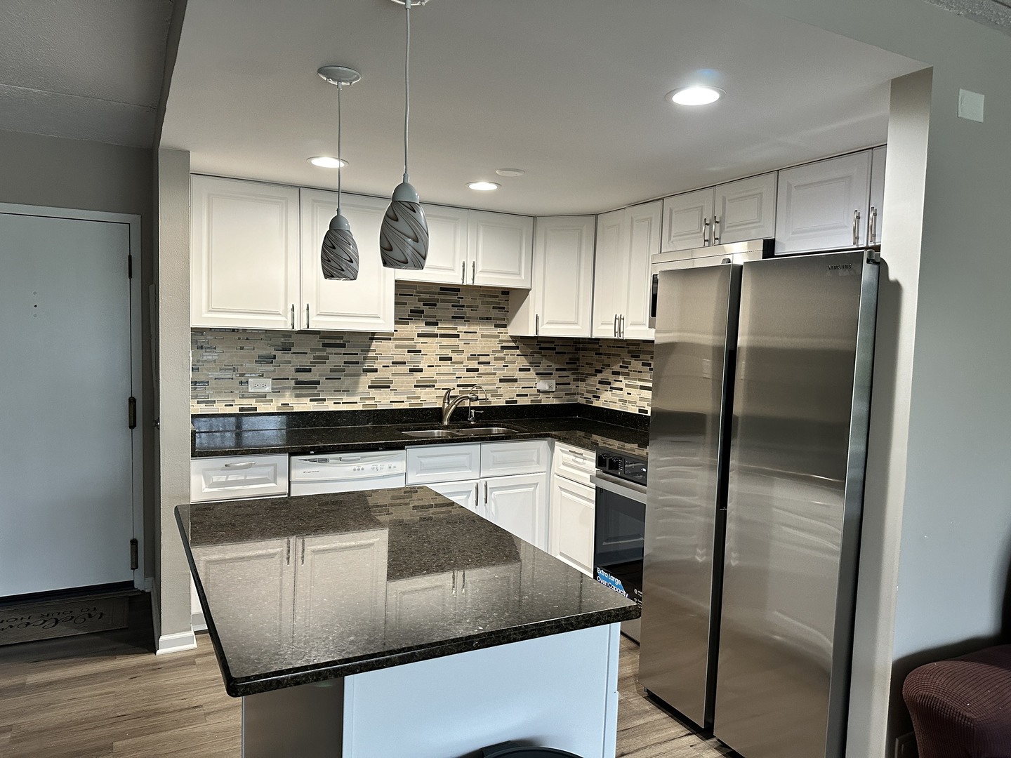 2015 South Finley Road, Unit 212 Lombard, IL 60148 - Photo 4 of 26 a kitchen with stainless steel appliances granite countertop a refrigerator a sink and a stove