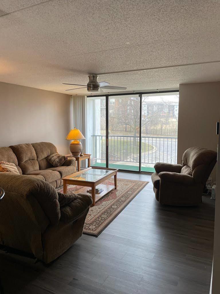 2015 South Finley Road, Unit 212 Lombard, IL 60148 - Photo 6 of 26 a living room with furniture and a large window