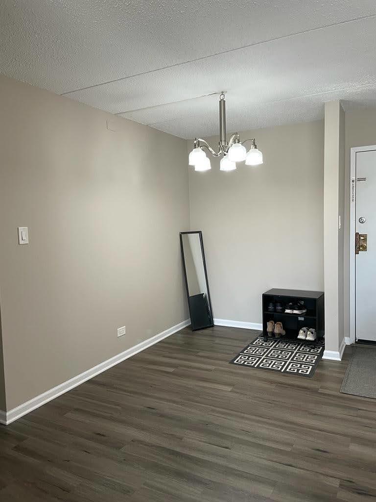 2015 South Finley Road, Unit 212 Lombard, IL 60148 - Photo 7 of 26 a view of wooden floor and a chandelier in a room