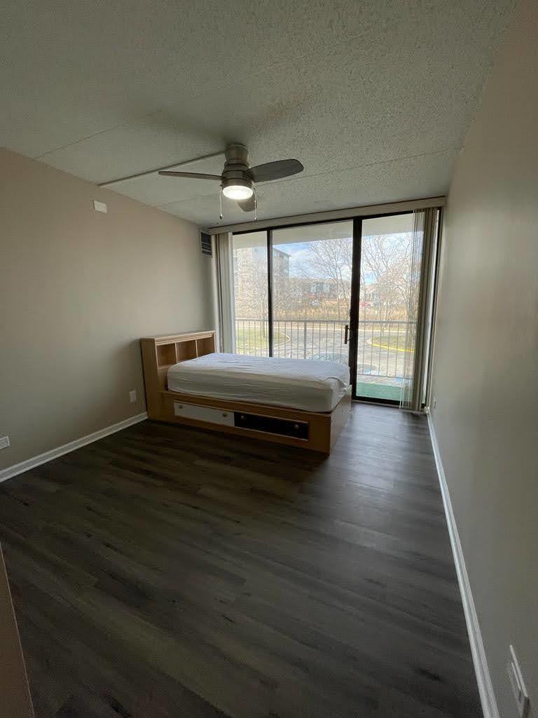 2015 South Finley Road, Unit 212 Lombard, IL 60148 - Photo 10 of 26 a room with a bed and a large window