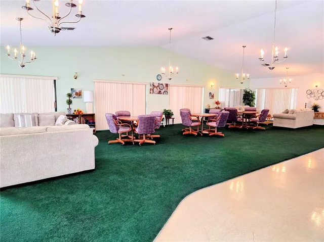 a living room with lots of table and chairs
