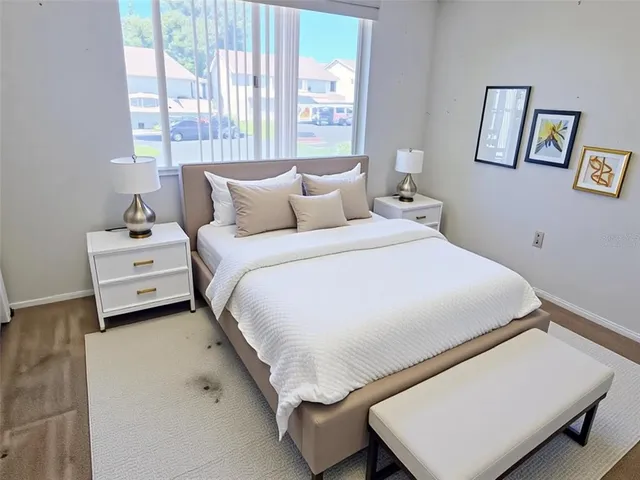 a bedroom with a bed and a night stand