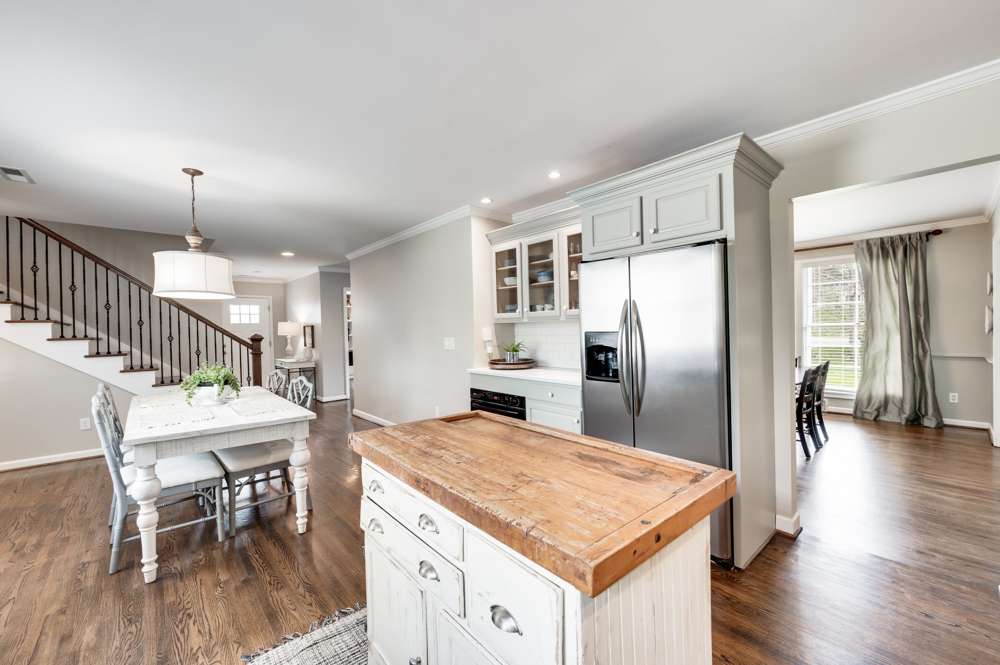 6337 Torrington Road Nashville, TN 37205 - Photo 23 of 70 a kitchen with stainless steel appliances kitchen island a table chairs in it and wooden floors