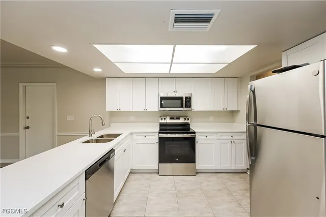 a kitchen with stainless steel appliances a refrigerator sink and stove
