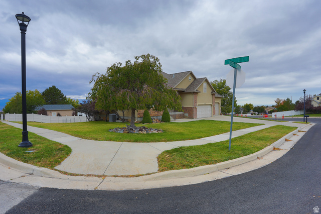 426 Deer Hollow Road Tooele, UT 84074 - Photo 26 of 37 View of front of home with a garage, driveway, a shingled roof, and brick siding