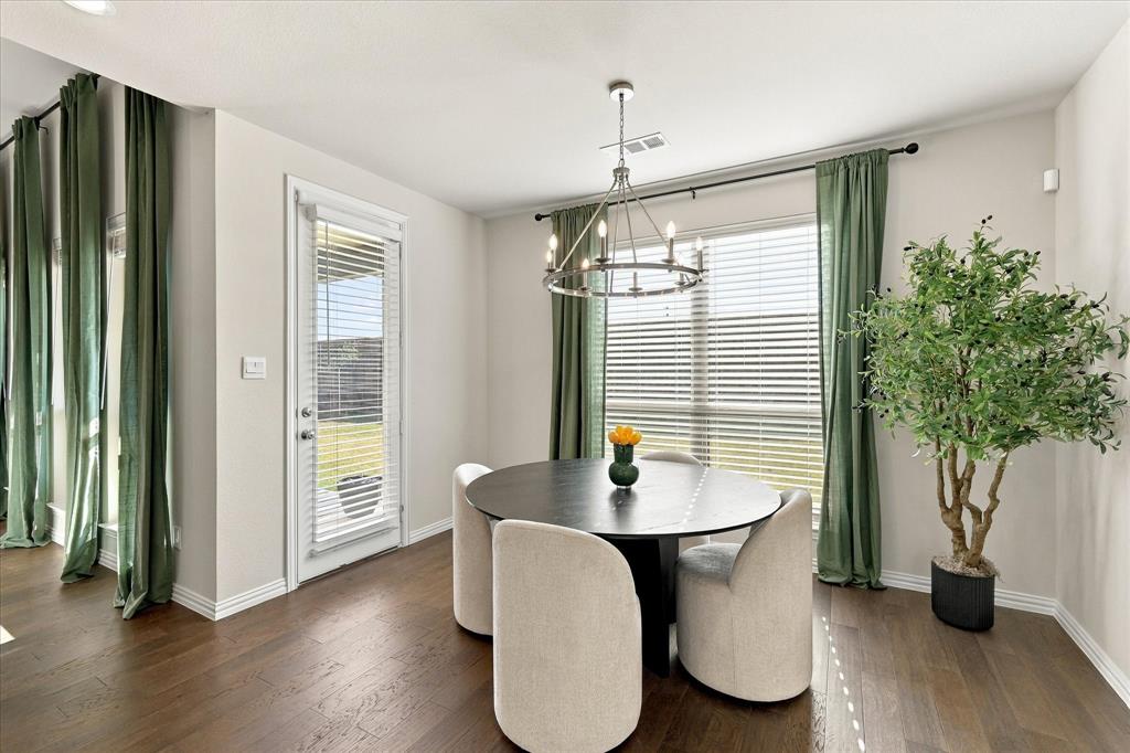 137 Chisos Court Rhome, TX 76078 - Photo 11 of 40 Wood-finish flooring, white baseboards, and a rear exterior door with integrated blinds
