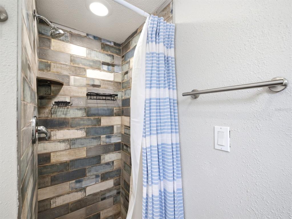 1207 1st Street Indian Rocks Beach, FL 33785 - Photo 21 of 60 a bathroom with a shower