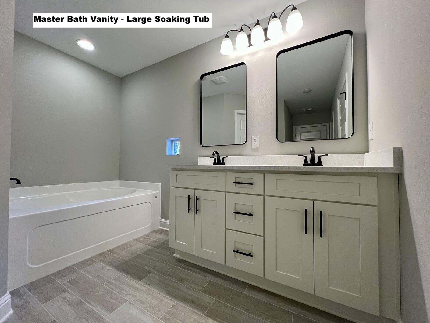 4644 Chanteuse Parkway Crestview, FL 32539 - Photo 14 of 34 a bathroom with a double vanity sink mirror and bathtub