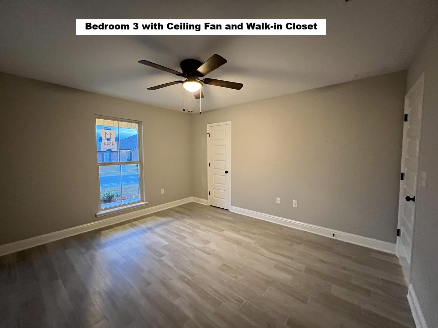 4644 Chanteuse Parkway Crestview, FL 32539 - Photo 20 of 34 an empty room with wooden floor ceiling fan and windows