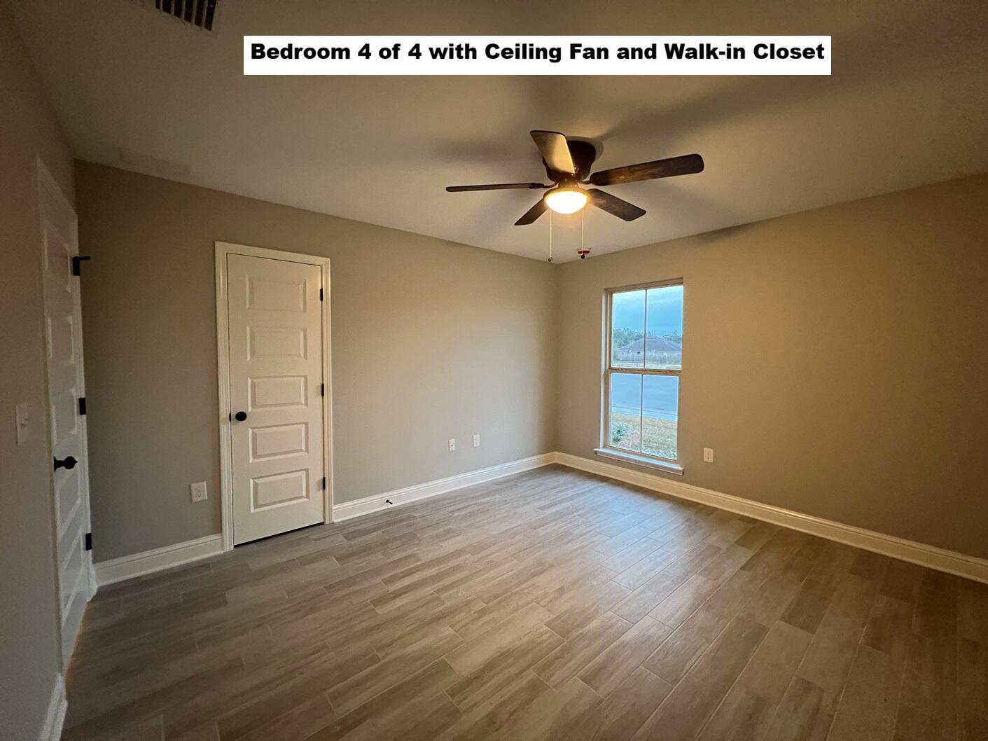 4644 Chanteuse Parkway Crestview, FL 32539 - Photo 22 of 34 a view of an empty room with wooden floor and a ceiling fan