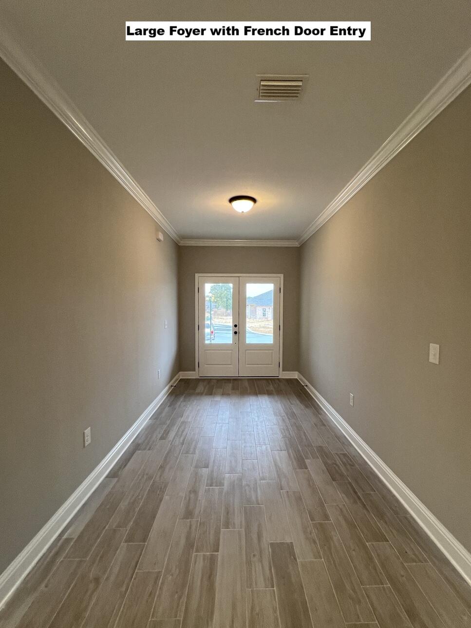 4644 Chanteuse Parkway Crestview, FL 32539 - Photo 27 of 34 an empty room with wooden floor and windows